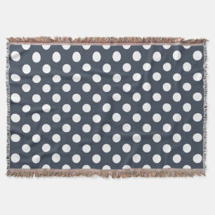 White polka dots on blue-gray throw blanket