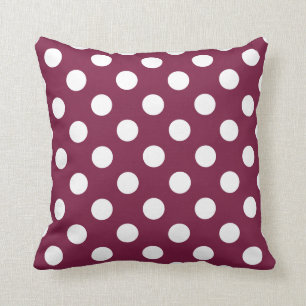 White polka dots on burgundy cushion
