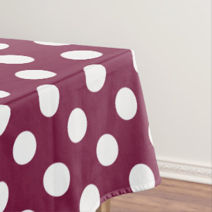 White polka dots on burgundy tablecloth