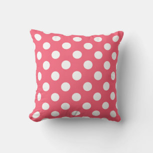 White polka dots on coral cushion
