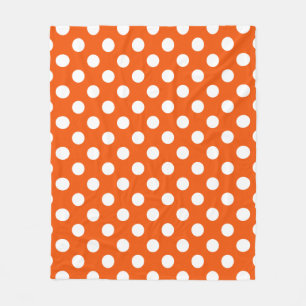 White polka dots on orange fleece blanket