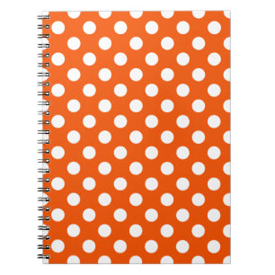 White polka dots on orange notebook
