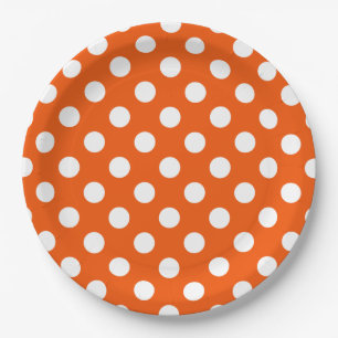 White polka dots on orange paper plate