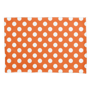White polka dots on orange pillowcase