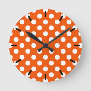 White polka dots on orange round clock