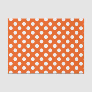 White polka dots on orange tissue paper