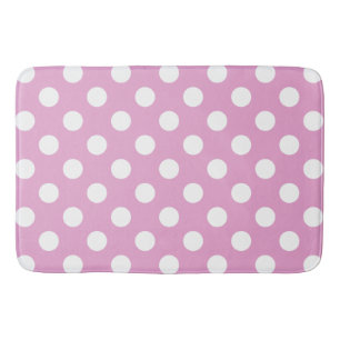 White polka dots on pale pink bath mat
