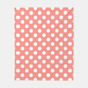 White polka dots on peach fleece blanket
