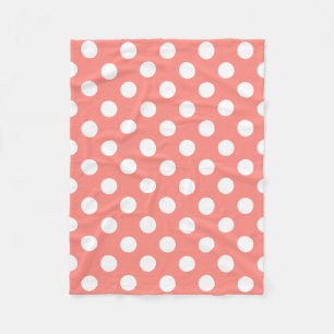 White polka dots on peach fleece blanket