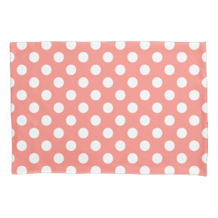 White polka dots on peach pillowcase