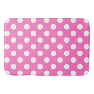 White polka dots on pink bath mat