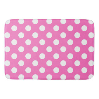 White polka dots on pink bath mat