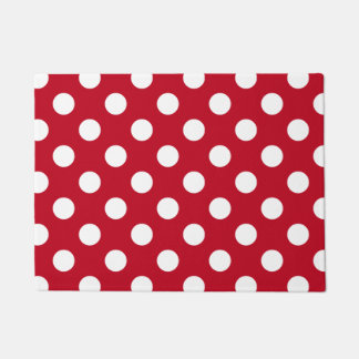 White polka dots on red doormat