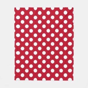 White polka dots on red fleece blanket