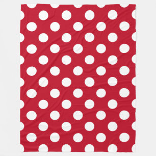 White polka dots on red fleece blanket