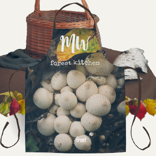 White puffball mushrooms among autumn leaves apron