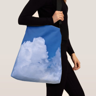White puffy clouds in blue sky crossbody bag