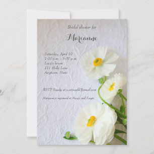 White ranunculus on textured paper invitation