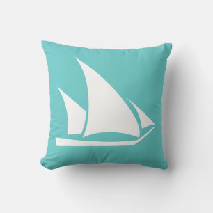 white sailboat  on teal blue pillow