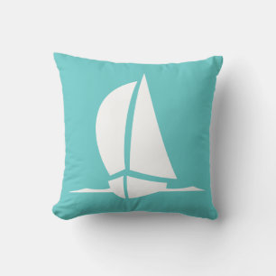 white sailboat  on teal blue pillow