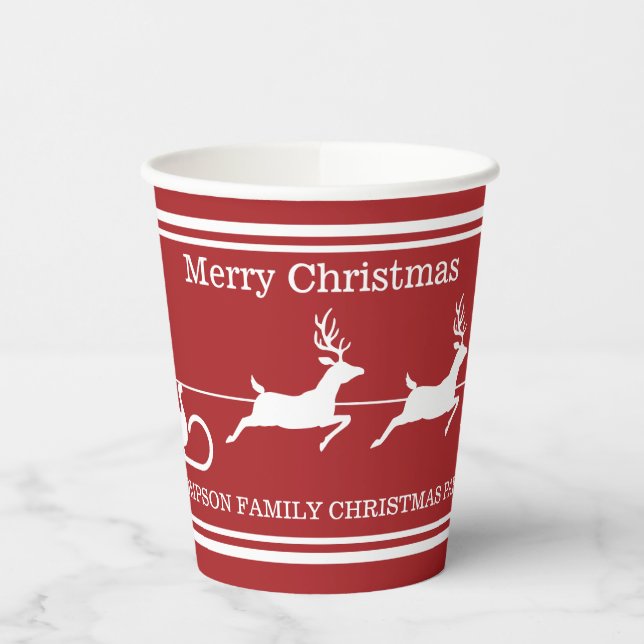 White Santa Sleigh And Merry Christmas Text On Red Paper Cups (Left)