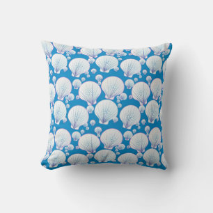 White sea shells on an ocean blue background cushion