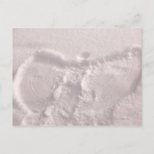 White snow imprinted with a snow angel postcard