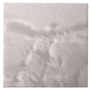 White snow imprinted with a snow angel tile
