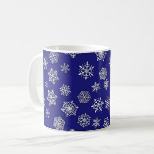 White snowflakes against deep cobalt blue coffee mug