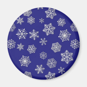 White snowflakes against deep cobalt blue magnet