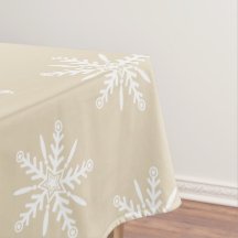 White snowflakes on beige Xmas tablecloth.