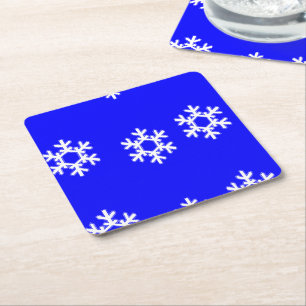 White snowflakes on blue square paper coaster