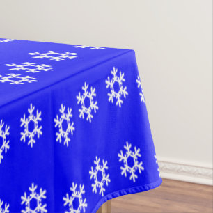 White snowflakes on blue tablecloth
