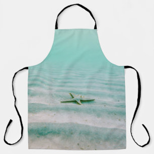 White starfish on sand underwater in the morning apron