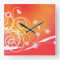 White swirls and florals on orange square clock