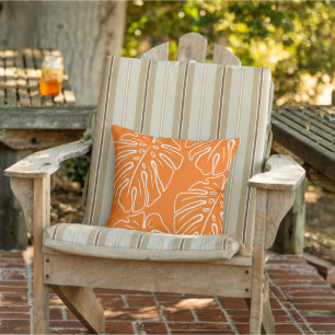White Tropical Leaf Motif On Bright Orange Cushion