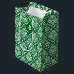 White vintage damasks pattern on Christmas green Medium Gift Bag<br><div class="desc">White vintage floral damask in a seamless pattern on a Christmas green background. The dark green background can be changed to any colour against the white damask to match the colours you need for your event.
Customisable one-letter monogram.</div>