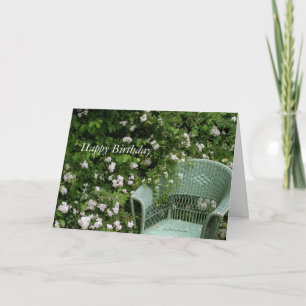 Wicker chair among blossoms Birthday Greeting Card