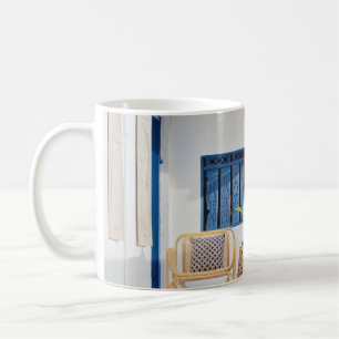 Wicker table and two chairs near swimming pool coffee mug