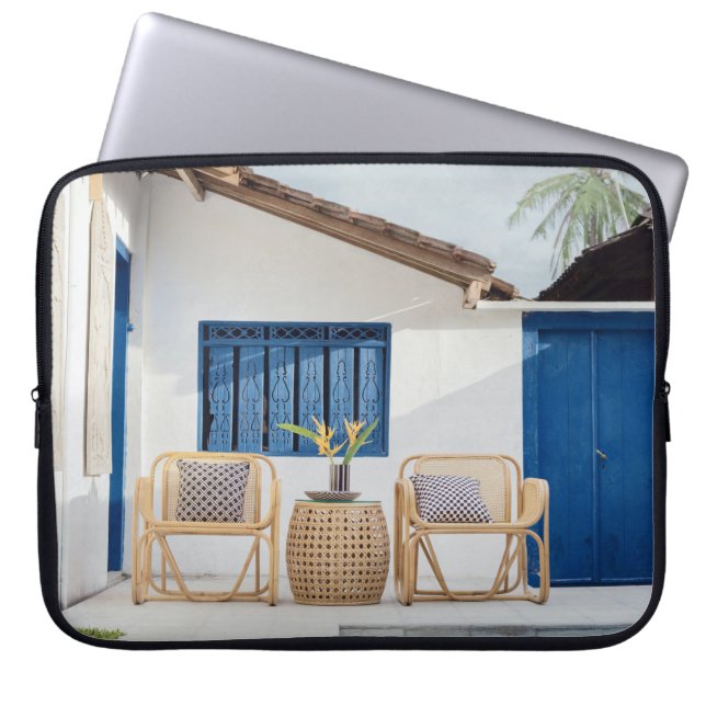 Wicker table and two chairs near swimming pool laptop sleeve (Front)