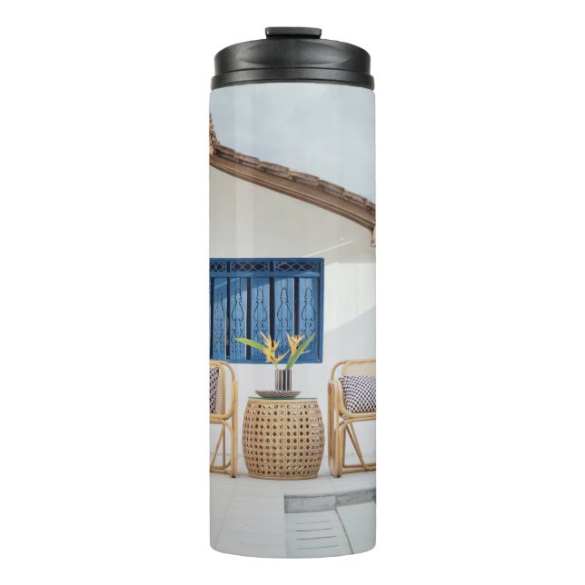 Wicker table and two chairs near swimming pool thermal tumbler (Front)