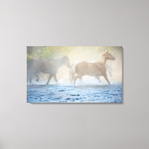 Wild horses running through water canvas print