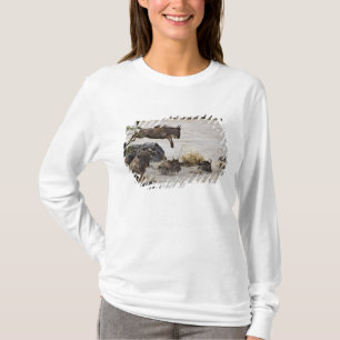 Wildebeest jumping into Mara River T-Shirt