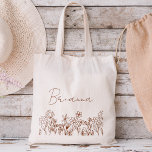 Wildflower Boho Bridesmaid Name Tote Bag<br><div class="desc">Elevate your bridesmaid proposal or thank-you gesture with our charming Wildflower Boho Bridesmaid Name Tote Bag! Crafted with love and adorned with intricate floral designs, this tote bag perfectly captures the essence of bohemian elegance. Each bag is personalised with your bridesmaid's name, adding a thoughtful touch that celebrates her unique...</div>