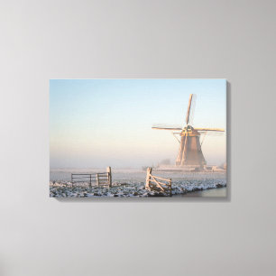 Windmill in the snow at sunrise canvas print