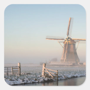 Windmill in the snow at sunrise square sticker