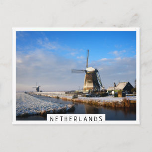 Windmill in the snow in a dutch winter landscape postcard