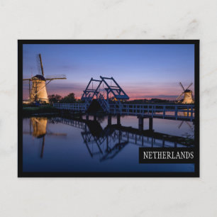 Windmills and a drawbridge at sunset edge postcard