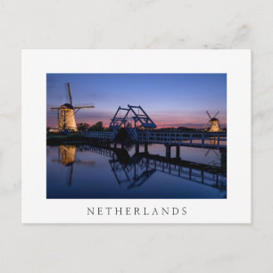 Windmills and drawbridge at sunset white postcard