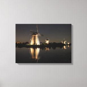 Windmills illuminated at night canvas print